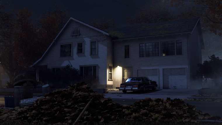 A two-storey suburban house at night with one lit window and a car in the driveway